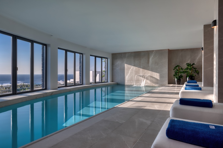 sandblu resort santorini greece greek cycladic minimalism white stucco blue accents indoor pool