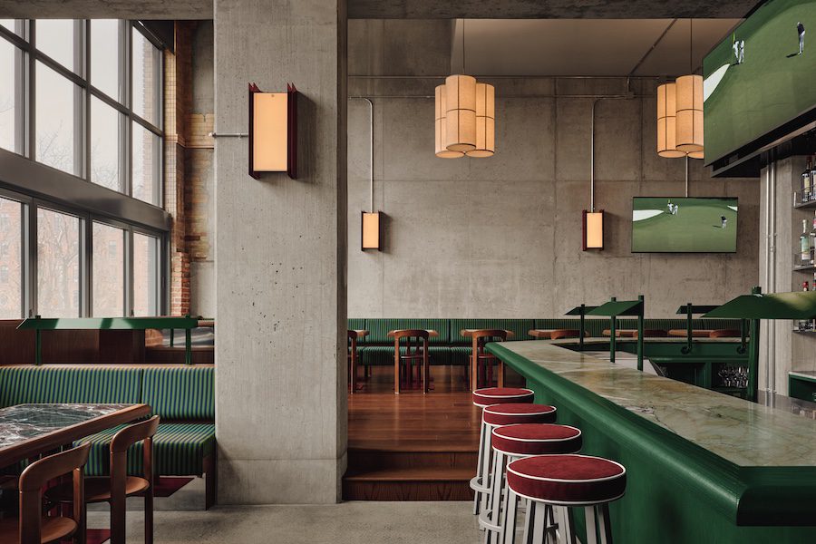 muni indoor immersive golf simulator industrial nordelec building adaptive reuse mint green restaurant bar red stools