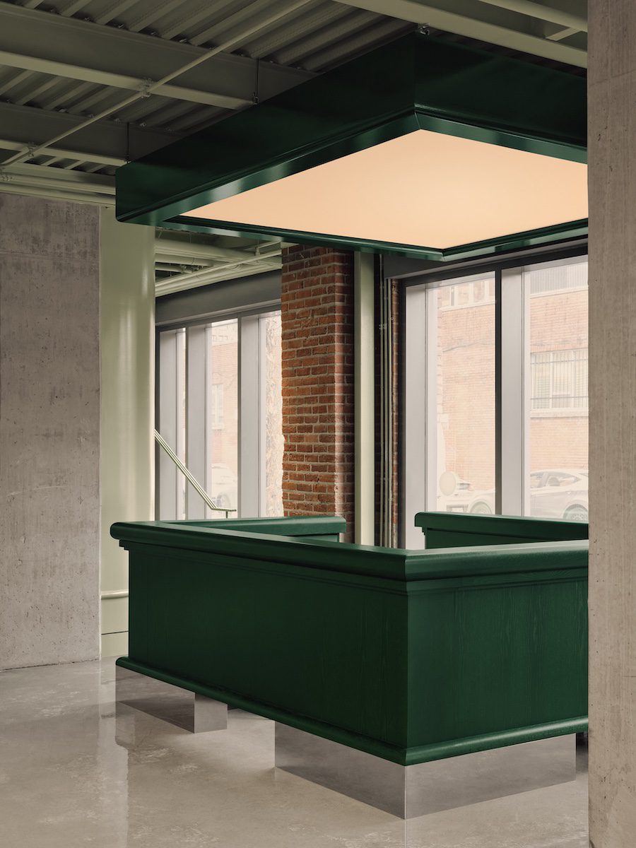 muni indoor immersive golf simulator industrial nordelec building adaptive reuse mint green dark green reception