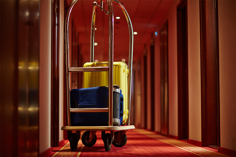 Cart of porter with suitcases hotel hallway