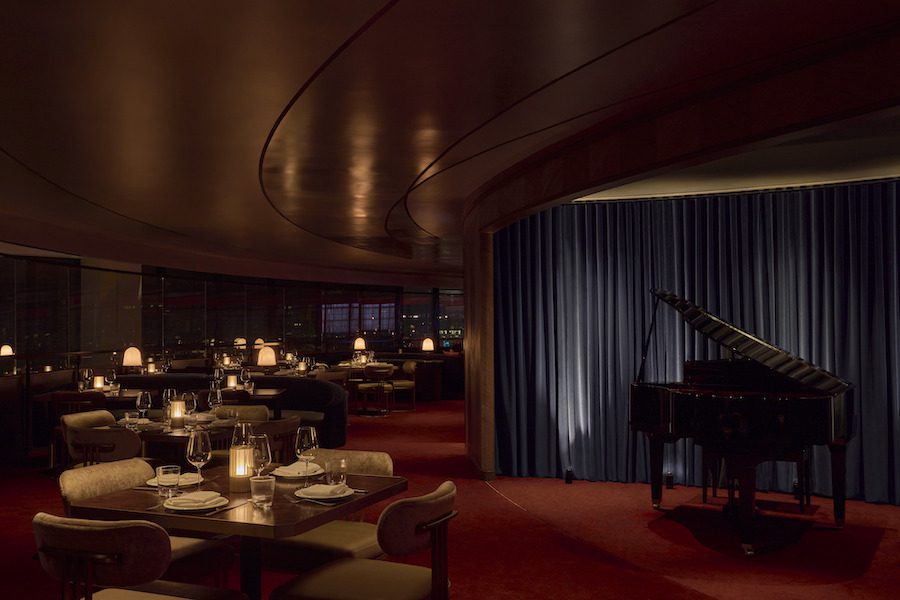 the view rotating spinning restaurant new york marriott marquis theater district union square hospitality group red flooring mirrors round curved walls grand piano blue curtain